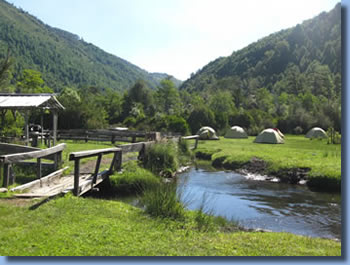 Bridge and creek at campsite on Sollipulli horse back trek in the Andes