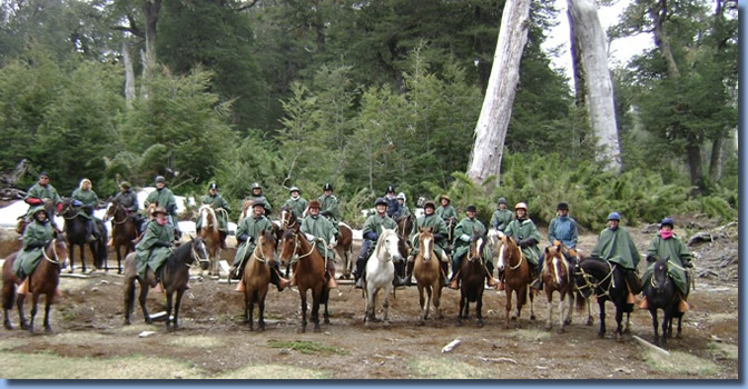Group foto of 23 riders in a forest on our TCT charity ride in the patagonian Andes in Chile